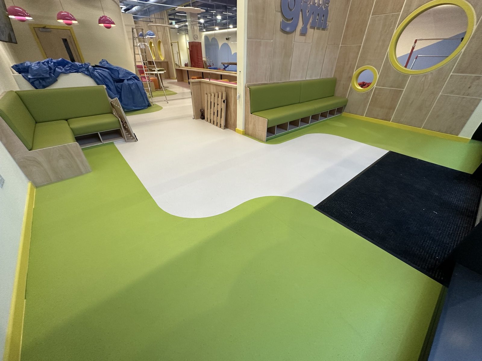 Education sector flooring — heavy-duty vinyl and carpet tiles installed in a UK school during a summer holiday programme